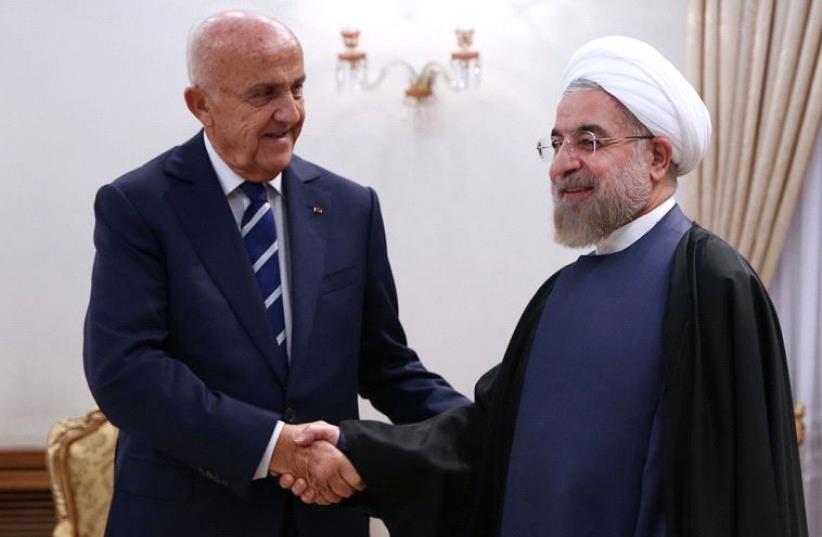 Iranian President Hassan Rouhani greeting Lebanese Defense Minister Samir Moqbel (L) at the presidential office in Tehran  (photo credit: AFP PHOTO / IRANIAN PRESIDENCY WEBSITE)