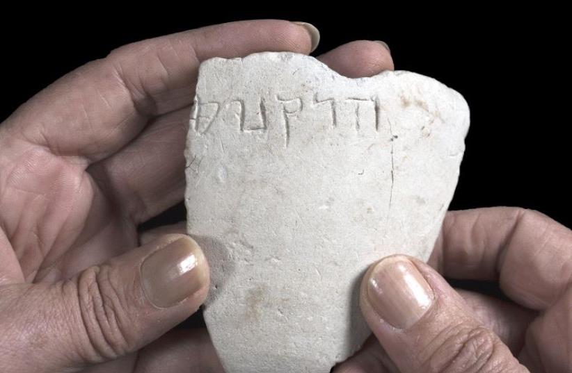 Letters found on a stone from the Hasmonean Dynasty says (photo credit: CLARA AMIT, COURTESY OF THE ISRAEL ANTIQUITIES AUTHORITY)