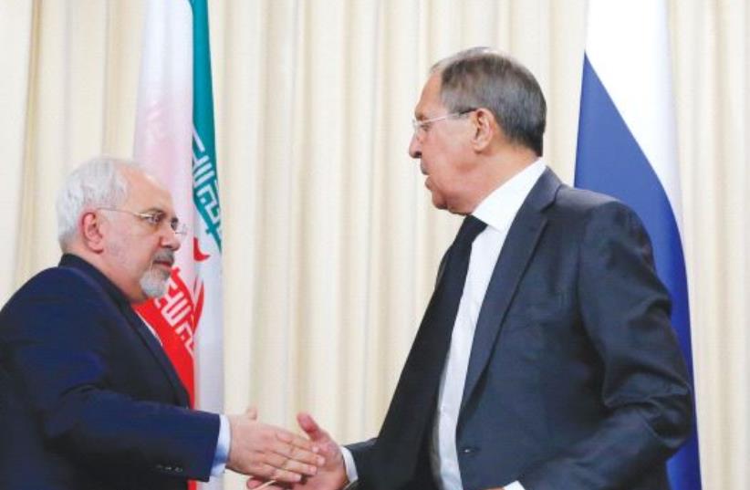 FOREIGN MINISTERS Sergei Lavrov of Russia (center) Mevlut Cavusoglu of Turkey (right) and Mohammad Zarif of Iran issued a declaration Tuesday on bringing an end to the Syrian civil war. (photo credit: REUTERS)