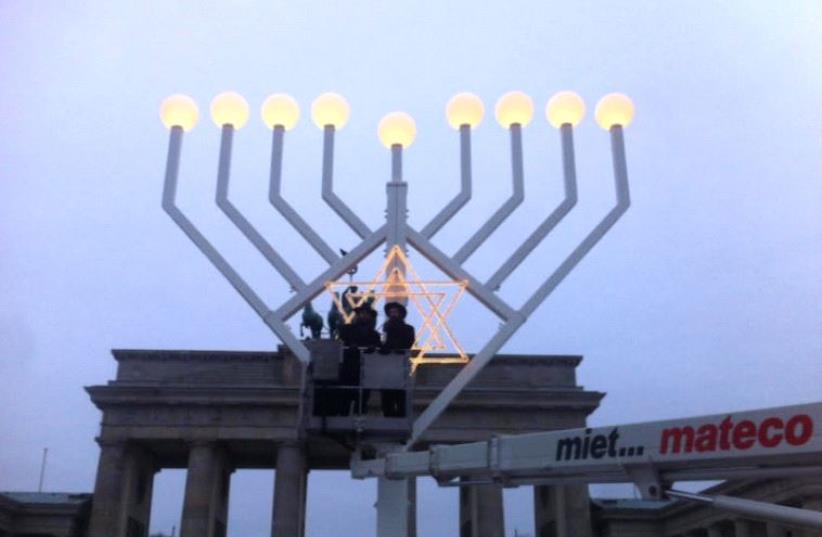 Rabbi Teichtel testing out menorah lighting in Berlin (photo credit: JTA)