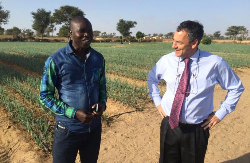 Ambassador Paul Hirschson at a small farm project supported by Israel in Senegal in March  (photo credit: SETH J. FRANTZMAN)