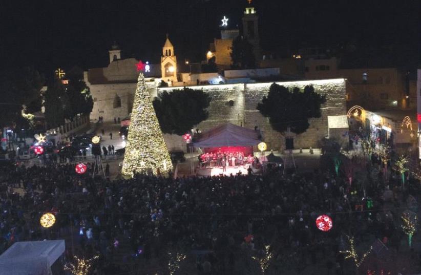 MANGER SQUARE in Bethlehem sparkles last night with the celebration of Christmas Eve. (photo credit: ADAM RASGON)