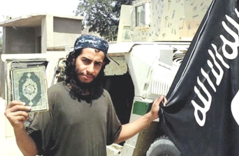 A PHOTOGRAPH of a man published in the Islamic State’s magazine and described as a Belgian national currently in Syria. He is believed to be one of Islamic State’s most active operators, suspected of being behind attacks in Paris, according to a source close to the French investigation. (photo credit: REUTERS)