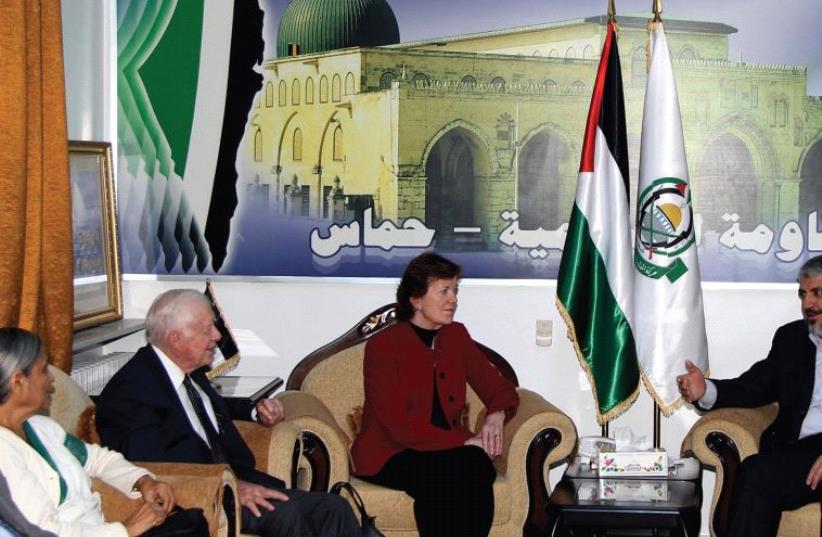 FORMER US President Jimmy Carter (third left) meets Hamas leader Khaled Mashaal (right) in Damascus alongside other members of a delegation of ‘The Elders,’ including Henry Kissinger (left), in 2010. (photo credit: REUTERS)