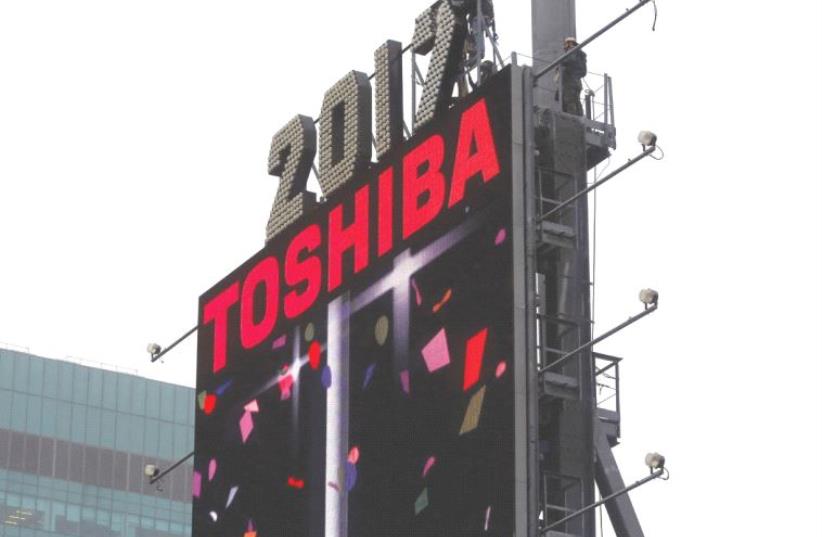 WORKERS PREPARE the New Year’s Eve numerals above a Toshiba sign in Times Square in Manhattan. (photo credit: REUTERS)