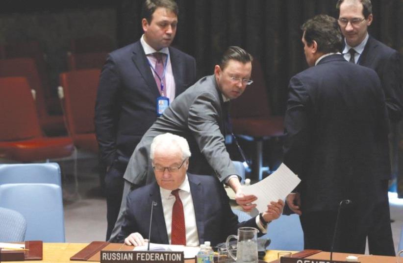 RUSSIA’S AMBASSADOR to the UN Vitaly Churkin sits in the security council chamber following a United Nations Security Council meeting. (photo credit: REUTERS)
