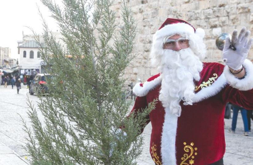 CELEBRATING CHRISTMAS in Jerusalem. According to the author, homegrown assimilation tops the list of threats to the survival and future of the Jewish people. ( (photo credit: MARC ISRAEL SELLEM/THE JERUSALEM POST)