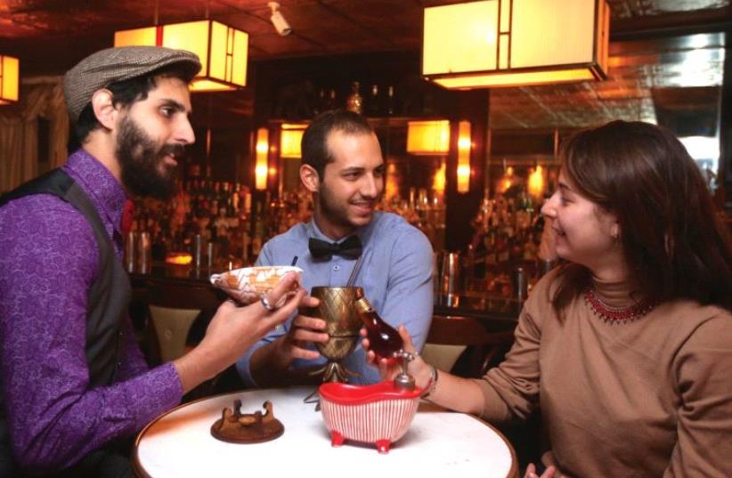 PATRONS DRINK at Jerusalem’s 1920s-themed Gatsby Cocktail Room yesterday. (photo credit: MARC ISRAEL SELLEM/THE JERUSALEM POST)