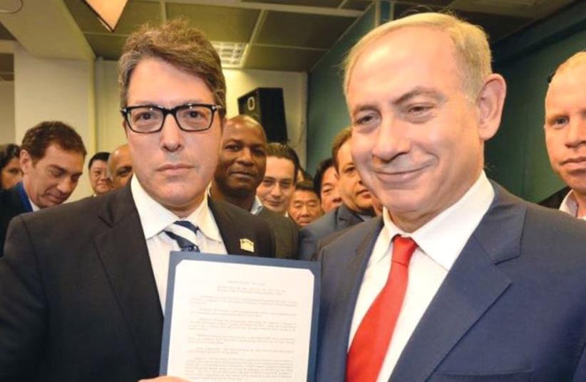 ON A TRIP to Israel in November, Beverly Hills Mayor John Mirisch presents Prime Minister Benjamin Netanyahu with a copy of Beverly Hills City Council resolution 16-R-13114 calling upon UNESCO to acknowledge the deep Jewish connection with Israel’s capital Jerusalem. ( (photo credit: COURTESY JOHN MIRISCH)