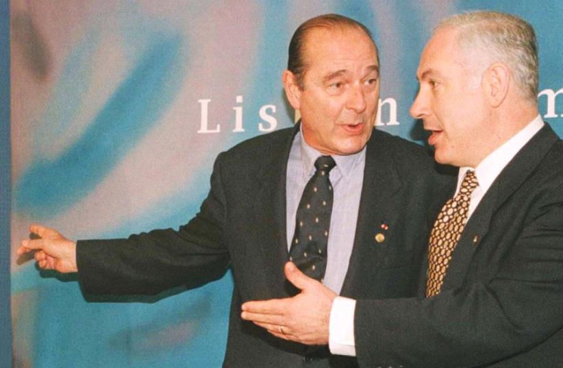 FORMER FRENCH PRESIDENT Jacques Chirac gestures as he talks with Prime Minister Benjamin Netanyahu before a bilateral meeting over security concerns in Lisbon in 1996. In recent days, Netanyahu sympathizers are looking to the ‘French Law’ whereby a sitting prime minister cannot be investigated for m (photo credit: REUTERS)