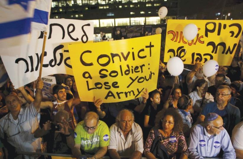 SUPPORTERS OF Elor Azaria, the soldier recently convicted of manslaughter, take part in a protest. (photo credit: REUTERS)