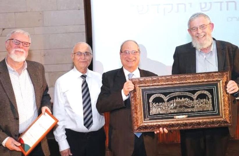 RABBI YEHUDA BRANDES (right), president of Herzog Academic College, makes a presentation to Dr. Yair Barkai, the former president of Lifshitz College, in the presence of Rabbi Shlomo Brinn, one of the heads of the Har Etzion Yeshiva. (photo credit: Courtesy)