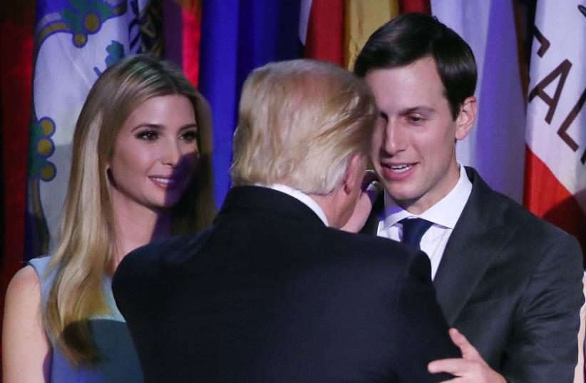  President-elect Donald Trump embraces son in law Jared Kushner,(R) (photo credit: AFP PHOTO)