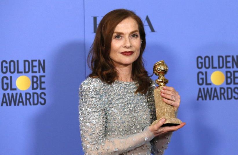 Actress Isabelle Huppert poses backstage with her award for Best Performance by an Actress in a Motion Picture - Drama for her role in "Elle," at the 74th Annual Golden Globe Awards. (photo credit: REUTERS)