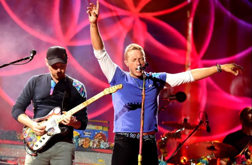  Musician Jonny Buckland (L) and singer Chris Martin of Coldplay perform at the Rose Bowl on August 20, 2016 in Pasadena, California (photo credit: KEVIN WINTER / GETTY IMAGES NORTH AMERICA / AFP)