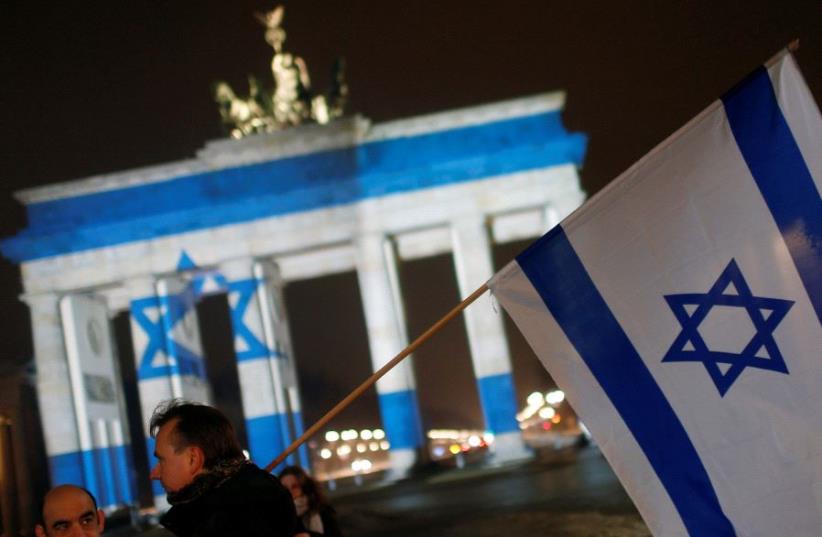 The Brandenburg Gate in Berlin, Germany, is illuminated with the colours of the Israeli flag to show solidarity with Israel (photo credit: REUTERS)