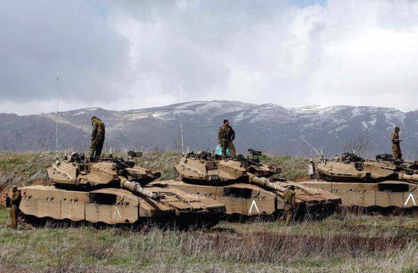 IDF tanks are seen along the Golan Heights border with Syria (photo credit: REUTERS)