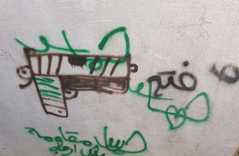 An image of the graffiti praising the terrorist in Sunday’s attack. (photo credit: POLICE SPOKESPERSON'S UNIT)