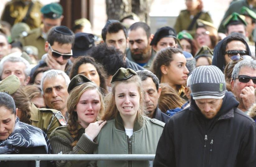 RELATIVES AND FRIENDS mourn during the funeral of IDF soldier Lt. Yael Yekutiel, who was killed on Sunday in the Jerusalem truck-ramming attack by a Palestinian terrorist (photo credit: REUTERS)