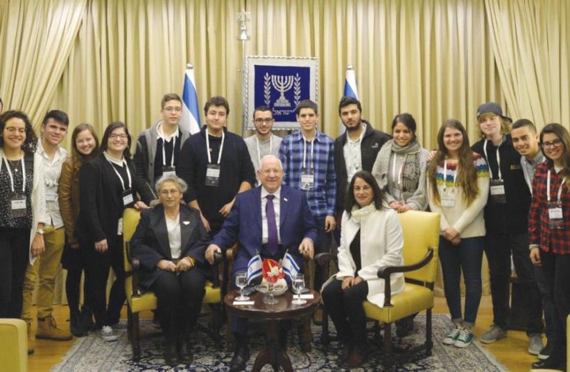 PRESIDENT REUVEN RIVLIN and his wife, Nechama, host Rona Ramon and students recognized for social leadership in a ceremony at the President’s Residence (photo credit: AMOS BEN-GERSHOM/GPO)