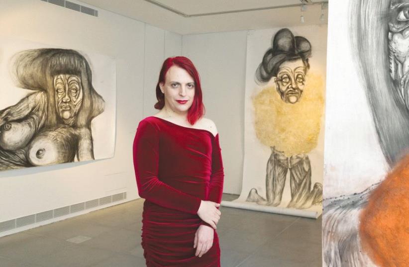 Roey Heifetz poses at her ‘Victoria’ exhibition in Jerusalem’s Beit Ticho. At right is the large portrait ‘Frau L.’ (photo credit: ELIE POSNER)