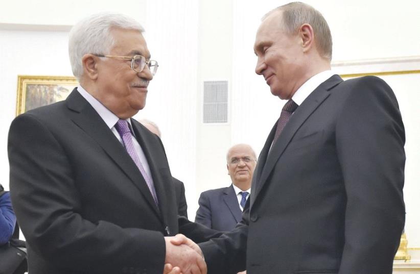 Russian President Vladimir Putin (right) shakes hands with PA President Mahmoud Abbas during their meeting at the Kremlin in Moscow, on April 18 last year (photo credit: REUTERS)