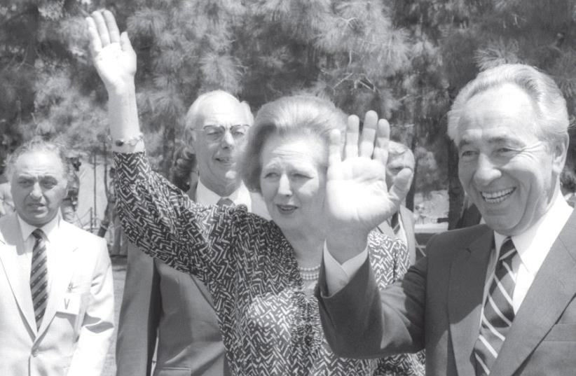 UK Prime Minister Margaret Thatcher waves to a crowd in Jerusalem alongside prime minister Shimon Peres in May 1986 (photo credit: YAACOV SAAR/GPO)
