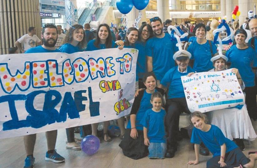 The Schwartzes are greeted at Ben-Gurion Airport by their two daughters’ families in August (photo credit: Courtesy)