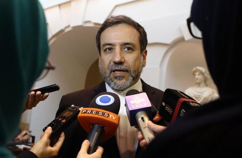 Iran's top nuclear negotiator Abbas Araqchi talks to journalists after meeting senior officials from the United States, Russia, China, Britain, Germany and France in a hotel in Vienna, Austria, October 19, 2015.  (photo credit: REUTERS)