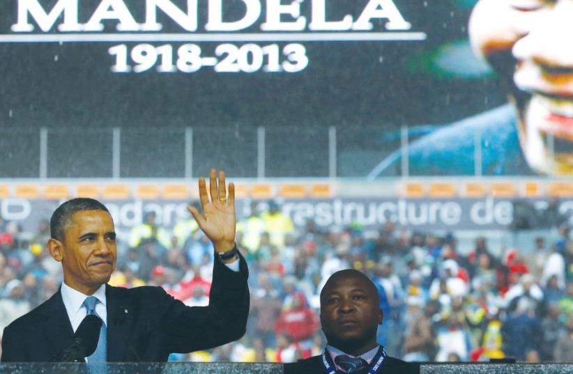 US PRESIDENT Barack Obama addresses the crowd during a memorial service for Nelson Mandela in Johannesburg, South Africa, in 2013. (photo credit: REUTERS)