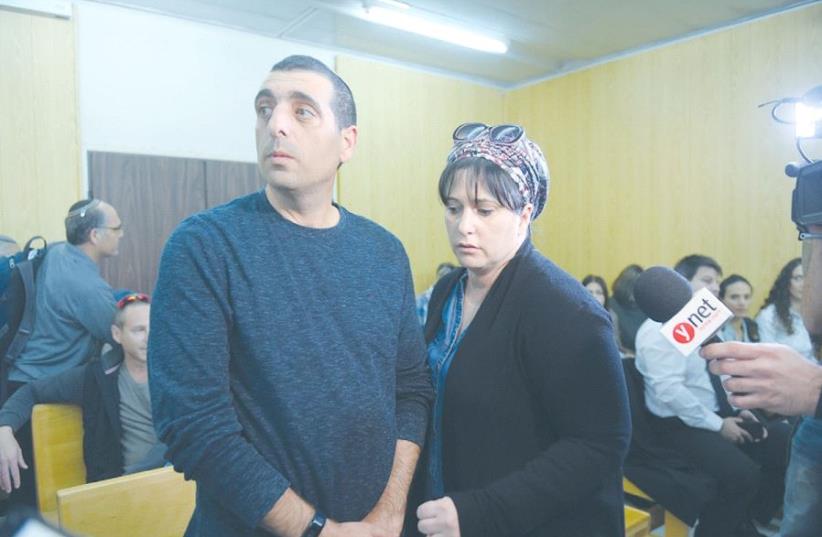 BRIG.-GEN. OFEK BUCHRIS stands with his wife, Naama, in court at the IDF headquarters in Tel Aviv yesterday. (photo credit: AVSHALOM SASSONI/MAARIV)