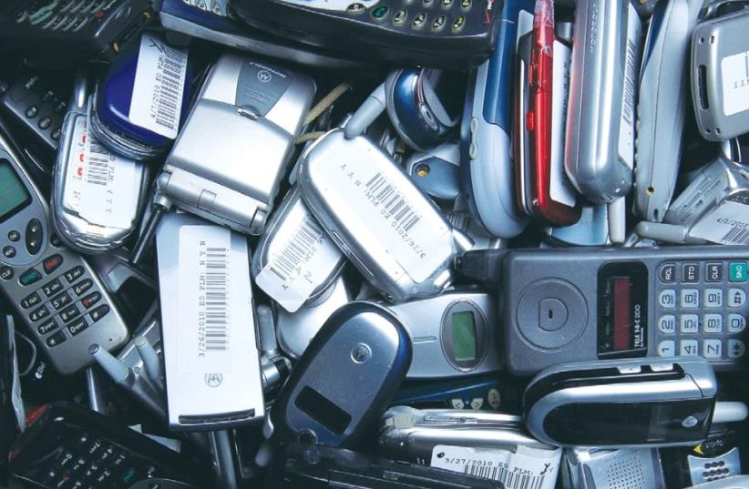 HUNDREDS OF used cellphones wait to be recycled at the offices of San Diego-based start-up ecoATM. (photo credit: REUTERS)