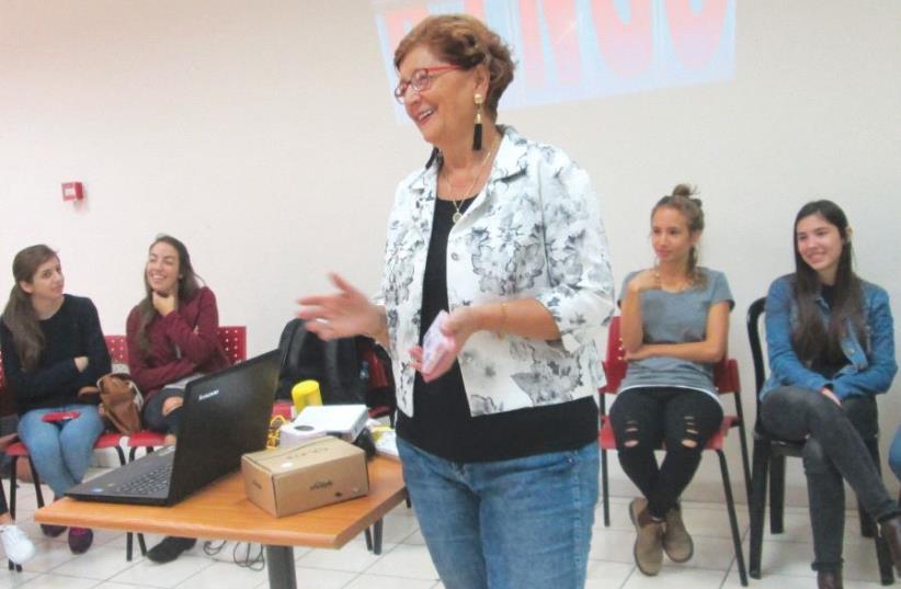 Sara Boxenbaum (center) introduces communication and hearing-disorder students from the University of Haifa, who presented club members with a quiz (photo credit: WENDY BLUMFIELD)