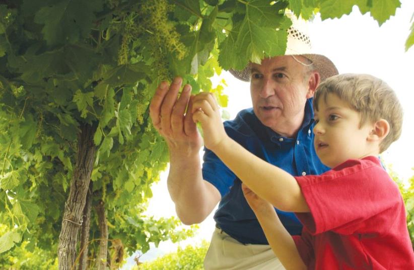 Moti Shor, seventh-generation owner of Arza and Hayotzer wineries, with his grandson, Daniel (photo credit: Courtesy)