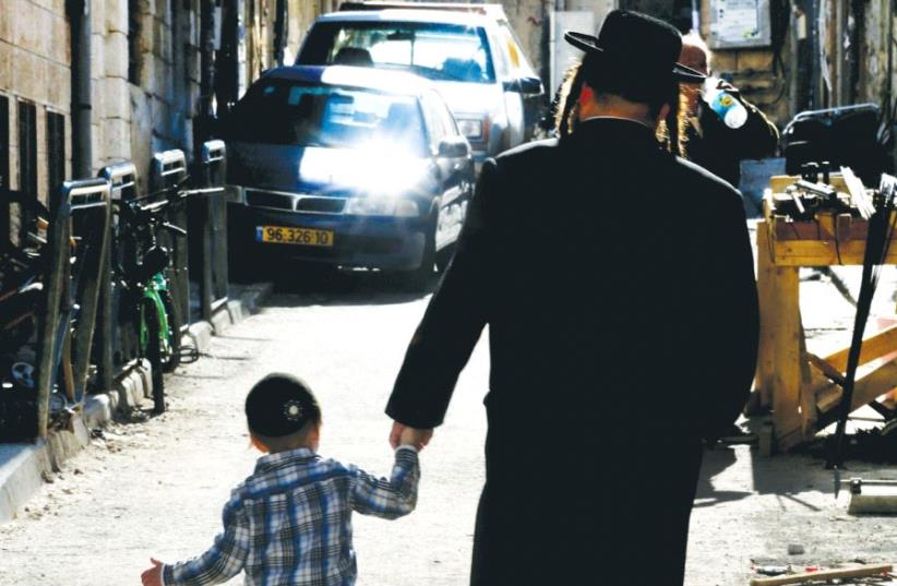 A Hassidic man with his child walking in Jerusalem (photo credit: MARC ISRAEL SELLEM)