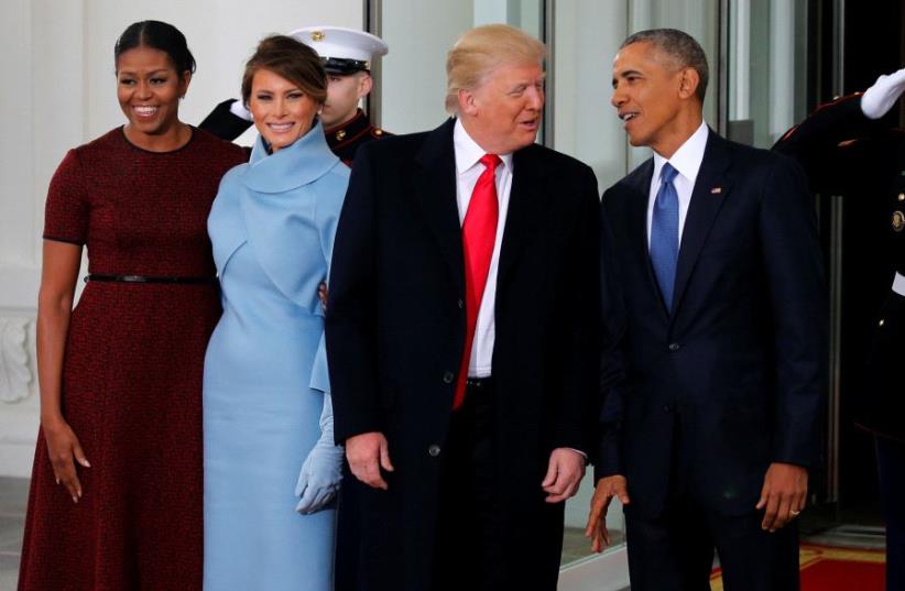US President Barack Obama (R) and first lady Michelle Obama (L) greet US President-elect Donald Trump and his wife Melania for tea before the inauguration at the White House. (photo credit: REUTERS)