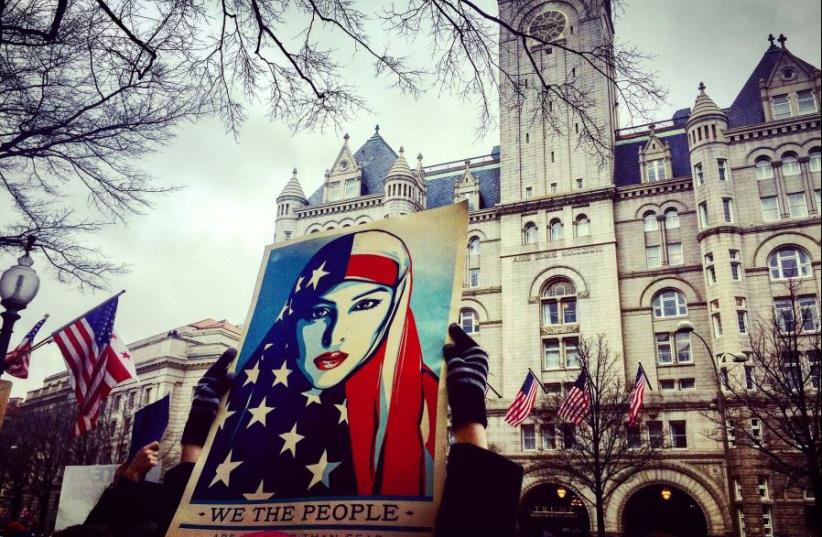 Protesters opposed to Donald Trump rally at Trump International Hotel on his inaugural parade route in Washington, DC. (photo credit: MICHAEL WILNER)