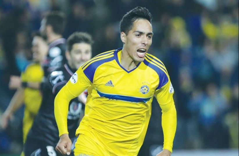 Maccabi Tel Aviv midfielder Oscar Scarione netted a brace in his return to the lineup last night, leading the yellow-and-blue to a 2-1 win over Bnei Sakhnin in Premier League action. (photo credit: YONI ARIELI)
