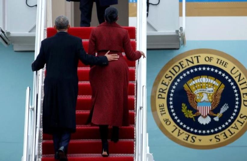 Obama and Michelle board Special Air Mission 28000, a Boeing 747 which serves as Air Force One (photo credit: REUTERS)