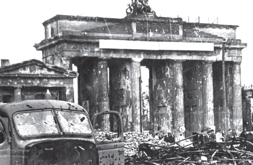 Once used by the Nazis as a party symbol, Berlin’s Brandenburg Gate remained intact after the war, though heavily damaged (photo credit: JERUSALEM POST ARCHIVE)