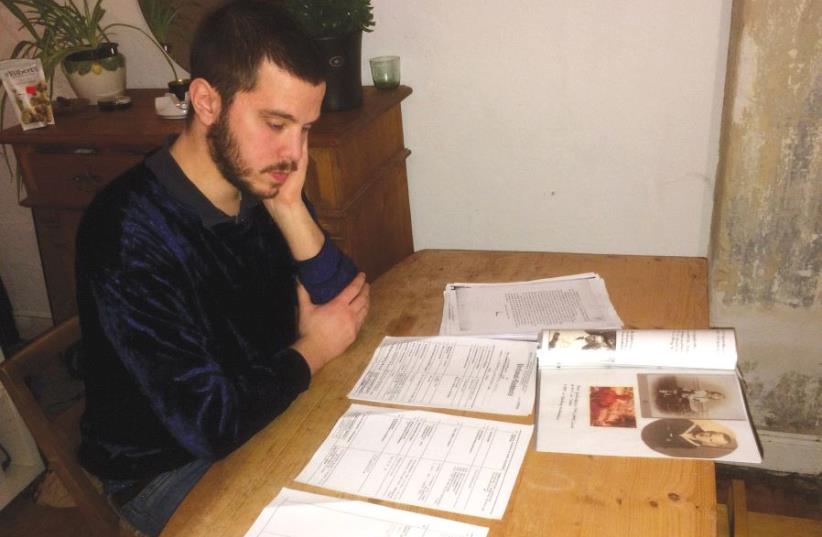 Hannover student Till Ewald examines family documents (photo credit: TILL EWALD)
