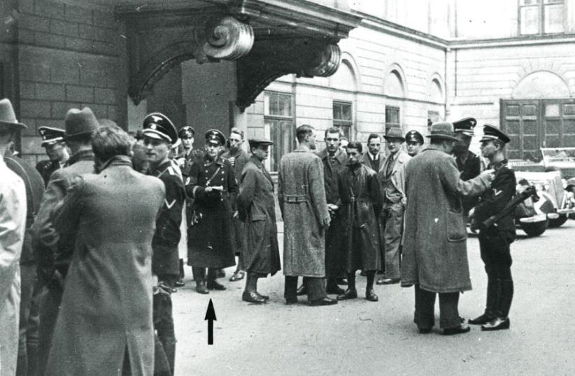 Police and SS, including Adolf Eichmann (see arrow), gather in a courtyard before the start of the round-up of the Jewish community in Vienna on March 18, 1938 (photo credit: DOCUMENTATION CENTER OF AUSTRIAN RESISTANCE)