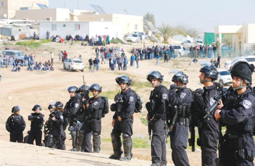 POLICE PROVIDE security for a home demolition in the Negev. (photo credit: REUTERS)