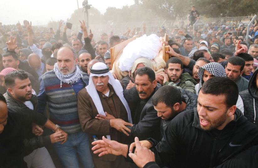 FRIENDS AND RELATIVES carry the body of Yacoub Abu al-Kiyan during his funeral in the Beduin village of Umm al-Hiran. (photo credit: AMMAR AWAD/REUTERS)