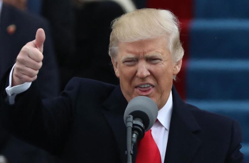 Newly inaugurated US President Donald Trump gives a thumbs up as he begins his inaugural address during ceremonies swearing him in as the 45th president of the United States on the West front of the U.S. Capitol in Washington, U.S., January 20, 2017 (photo credit: REUTERS)
