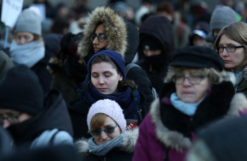 People observe a moment of silence for victims in a Quebec City mosque shooting, during a protest against US President Donald Trump's executive order travel ban in Toronto, Ontario, Canada January 30, 2017 (photo credit: CHRIS HELGREN/REUTERS)