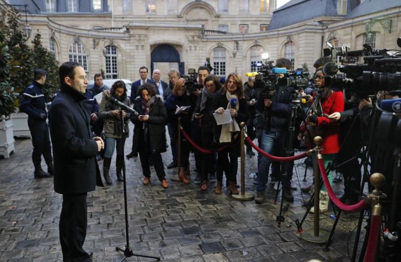 Benoit Hamon (L), French Socialist party's 2017 presidential candidate, talks to journalists as he leaves after a meeting with the French Prime Minister at the Hotel Matignon in Paris, France (photo credit: REUTERS)