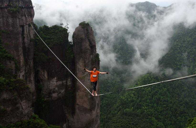 A competitor walks on tightrope (photo credit: REUTERS)