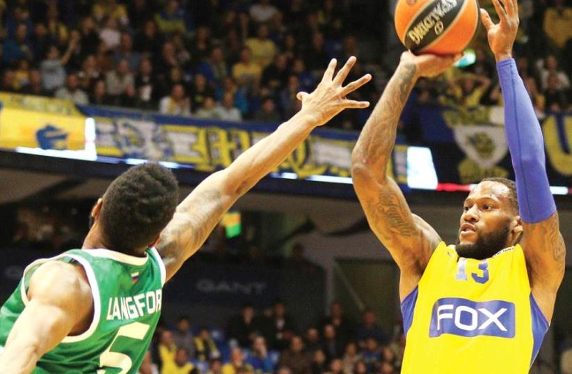 American forward Sonny Weems (right) shoots over Unics Kazan’s Keith Langford last Thursday in what looks likely to have been his last game for Maccabi Tel Aviv after he failed to complete an anti-doping test on Saturday (photo credit: ADI AVISHAI)