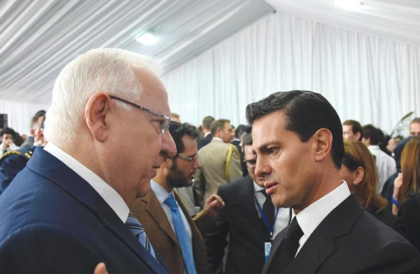 President Reuven Rivlin and his Mexican counterpart, Enrique Pena Nieto, exchange greetings at the funeral of Shimon Peres in Jerusalem in September. (photo credit: COURTESY OF TOMER REICHMAN)